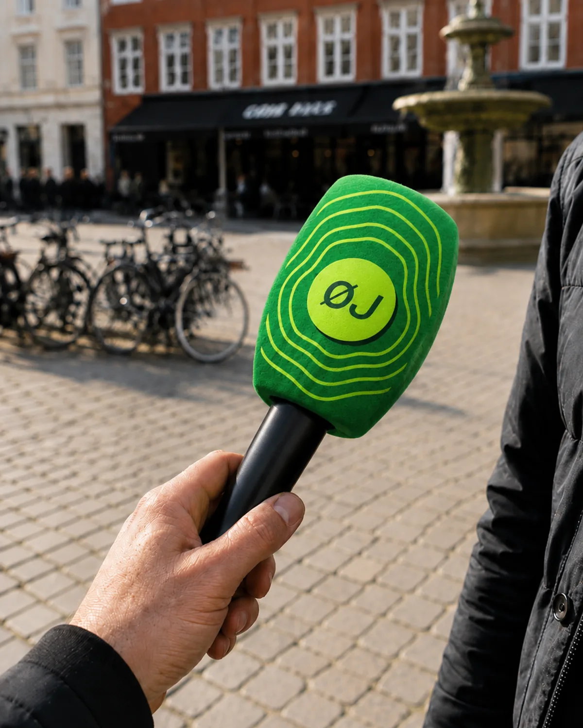 A microphone featuring the logo button and pulse rings